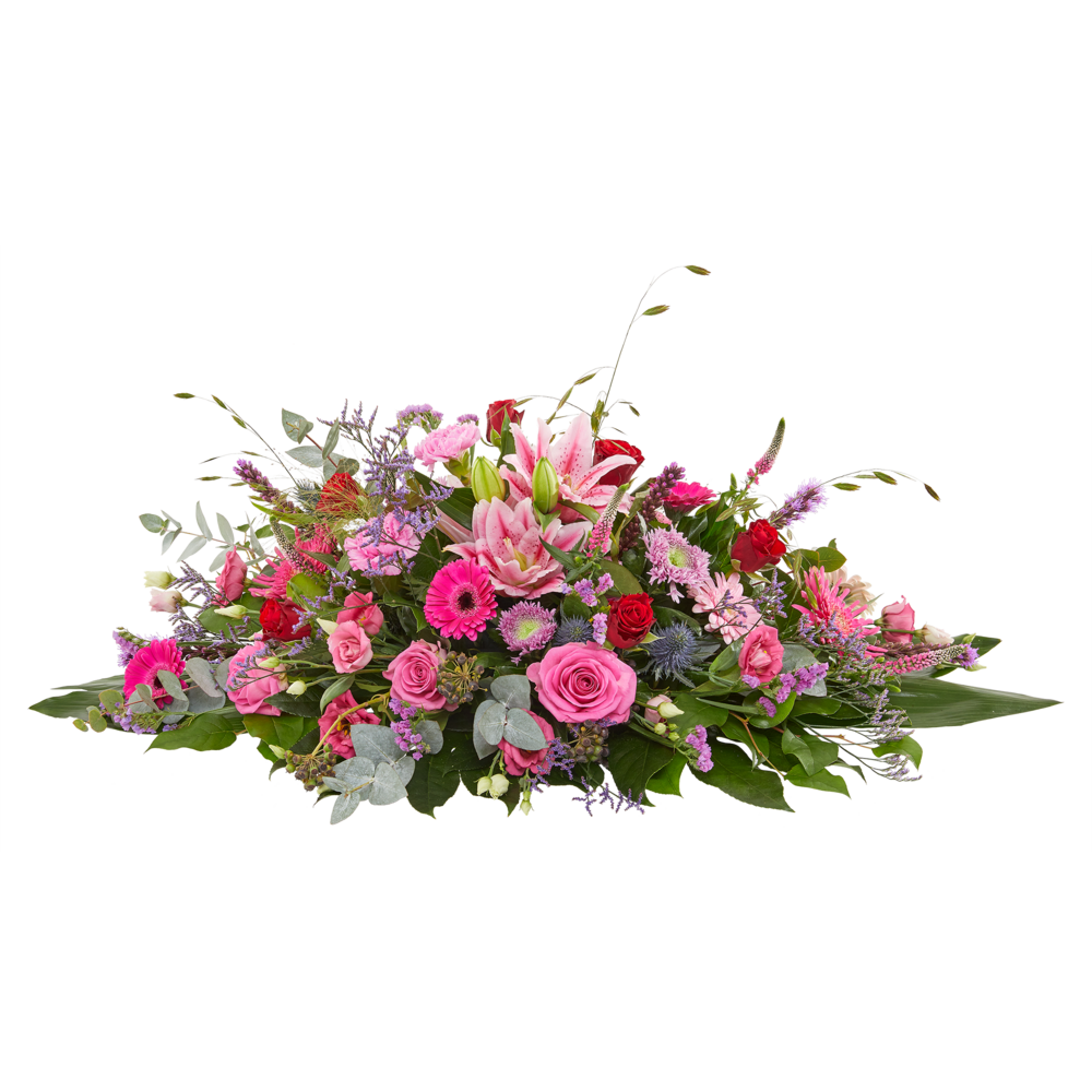 Ovaal rouwstuk met lelies, rozen en gerbera in warme roze en paarse tinten